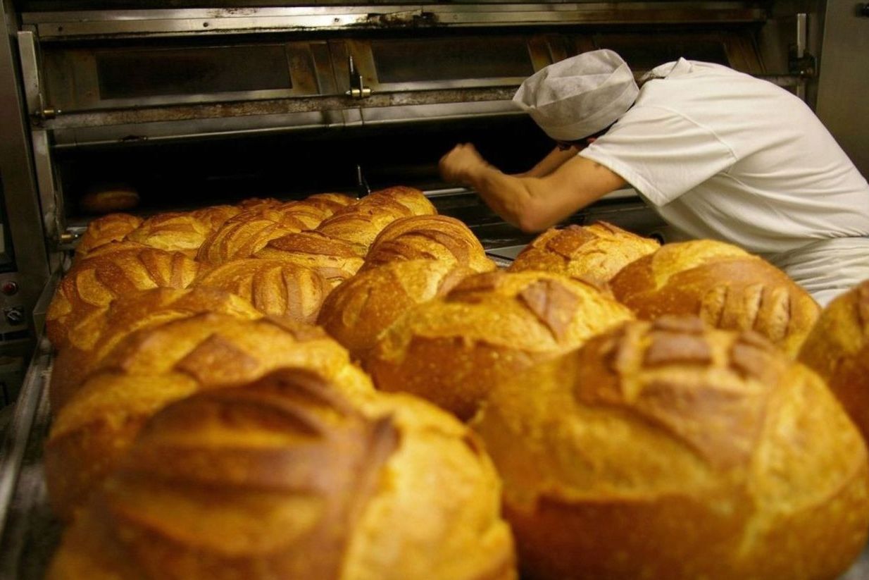 Baker shaping dough by hand